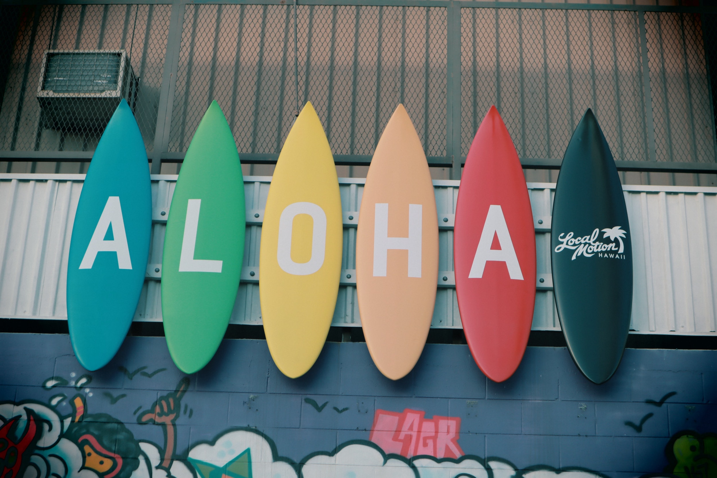 Surfboards with letters form the Hawaiian greeting “Aloha," photo © Little Plant for unsplash.com