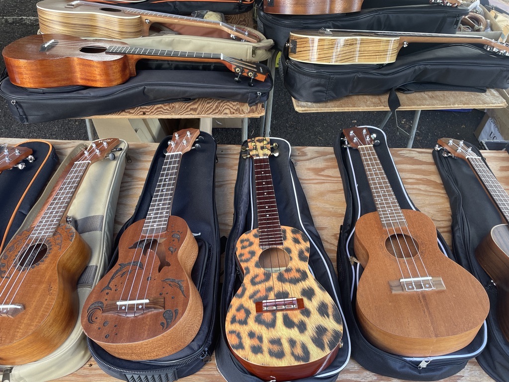 Colorful, wooden ukuleles on a table at the Aloha Swap Meet in Honolulu, just one of nine places to find unique souvenirs on Oahu. Photo © Kate Dana