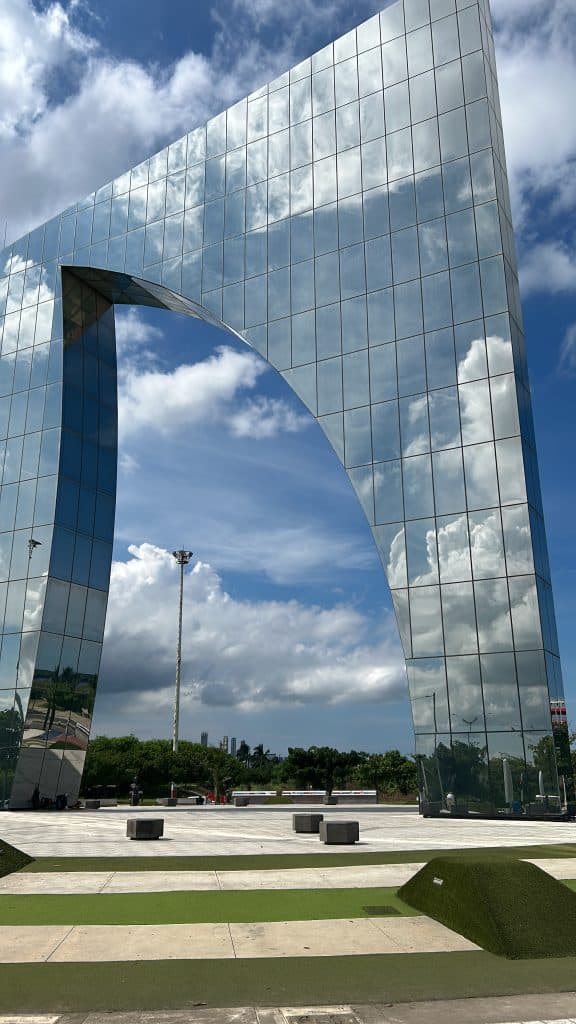 A daytime photo shows the reflective glass shark fin design of the Aleta de Juniors monument in Barranquilla, Colombia photo ©Kate Dana