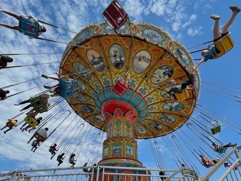 Colorful sea swings and riders high above on the Beach Boardwalk, perfect for a 4-Day solo getaway to Santa Cruz, California. Photo © Kate Dana