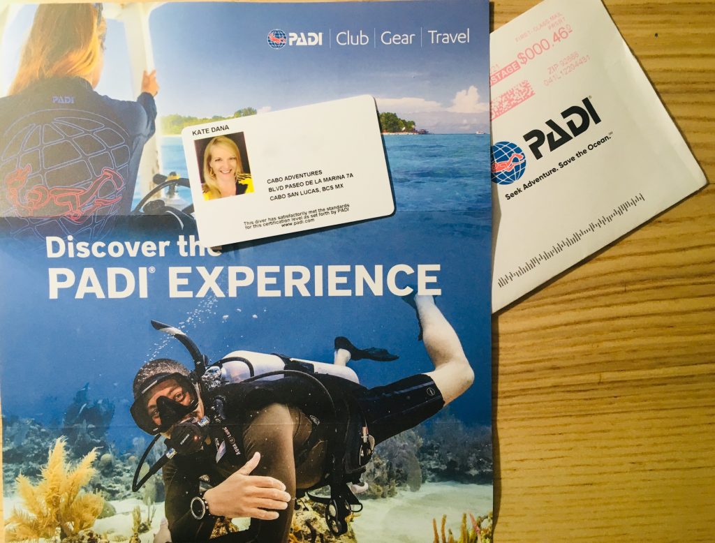 A PADI Dive Experience brochure with a Certified Advanced Diver Card photo © Kate Dana