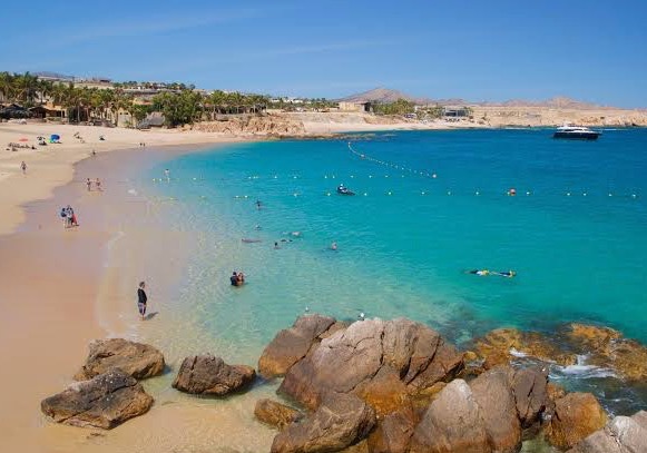 Soft sand and white-capped waves of blue water at a beach near Cabo San Lucas, Mexico photo © KateDana