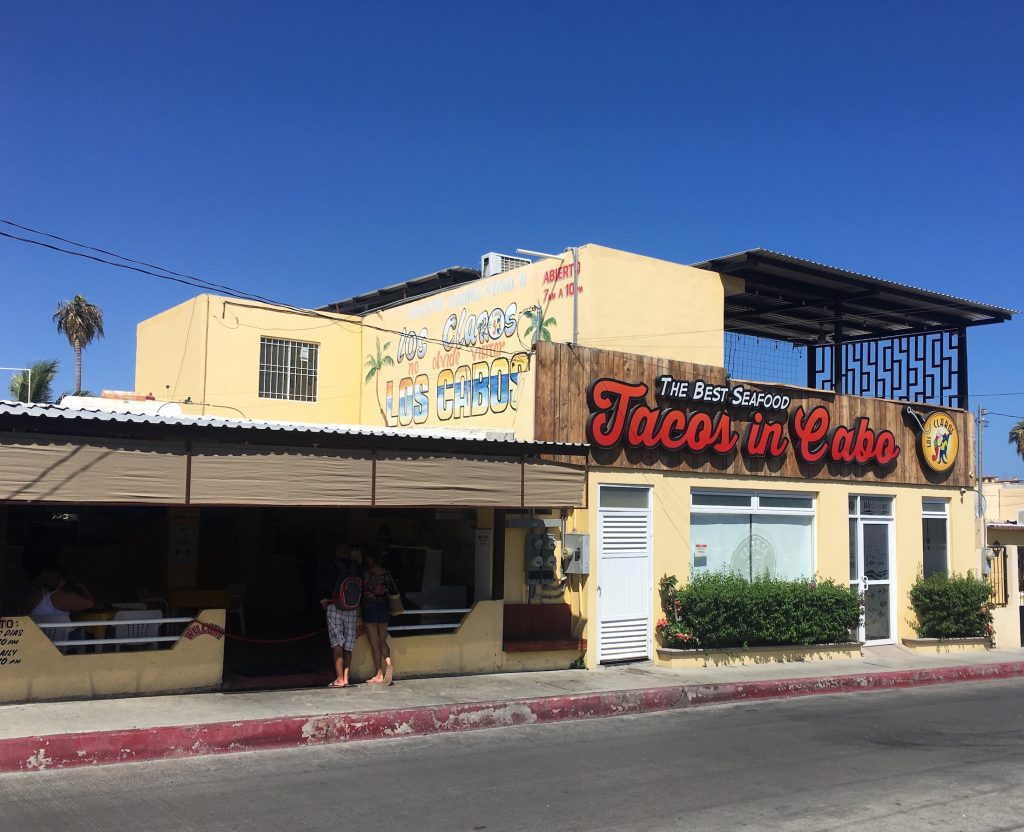 the colorful painted sign and outdoor facade of Tacos Los Claros in Cabo San Lucas, Mexico photo © Kate Dana