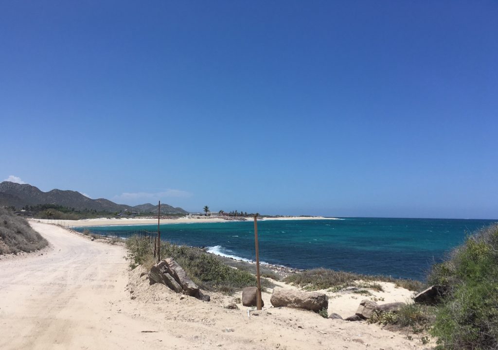 The sunny blue sky and white sand road make a wonderful view of Cabo Pulmo National Park upon arrival from Cabo San Lucas, Mexico photo © Kate Dana