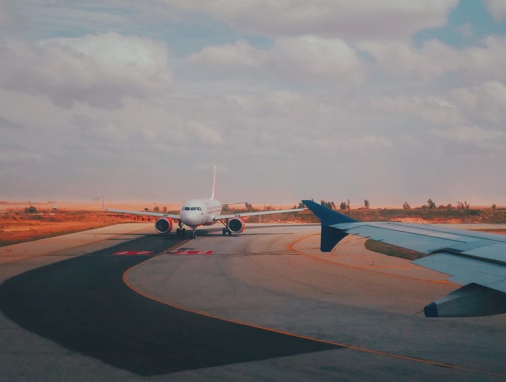 Two airplanes on a runway line up at dusk, photo ©Asif Methar for Pexels
