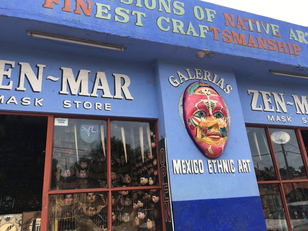 The vibrant lilac and blue facade with a colorful large mask outside of Zen Mar Mask Store in Cabo San Lucas, Mexico photo © Kate Dana