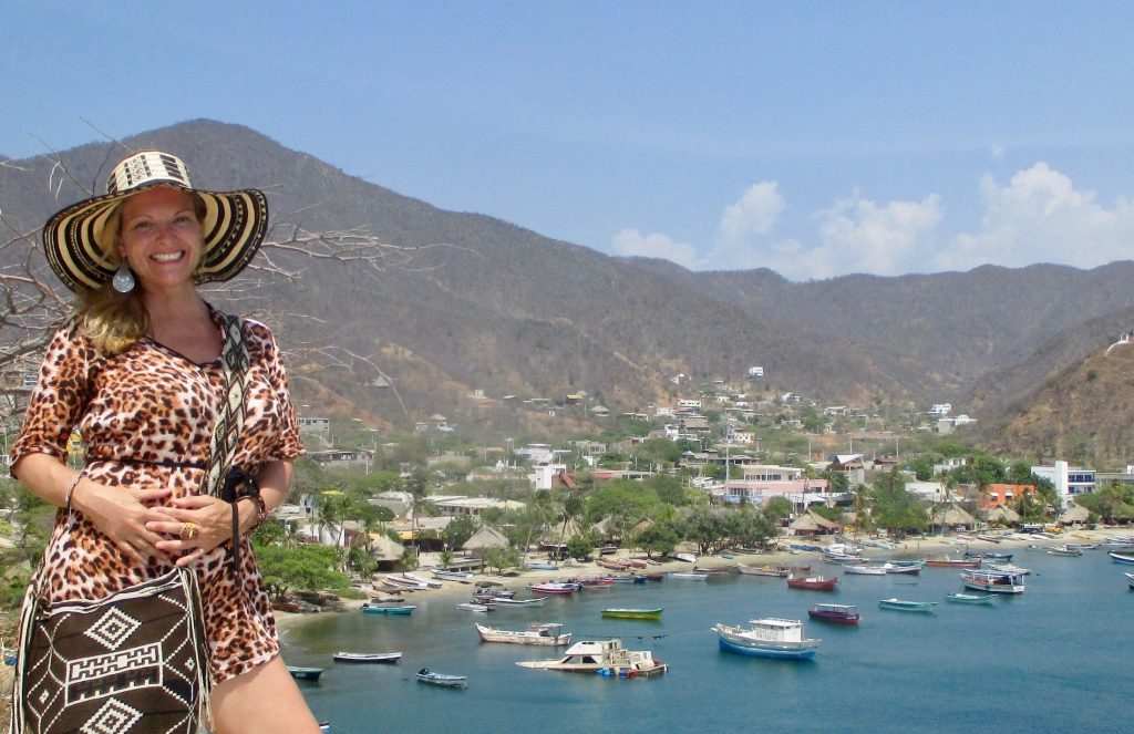 Kate Dana standing on a mountain overlooking a beach in Taganga, Santa Marta, Magdalena Colombia, photo ©Kate Dana