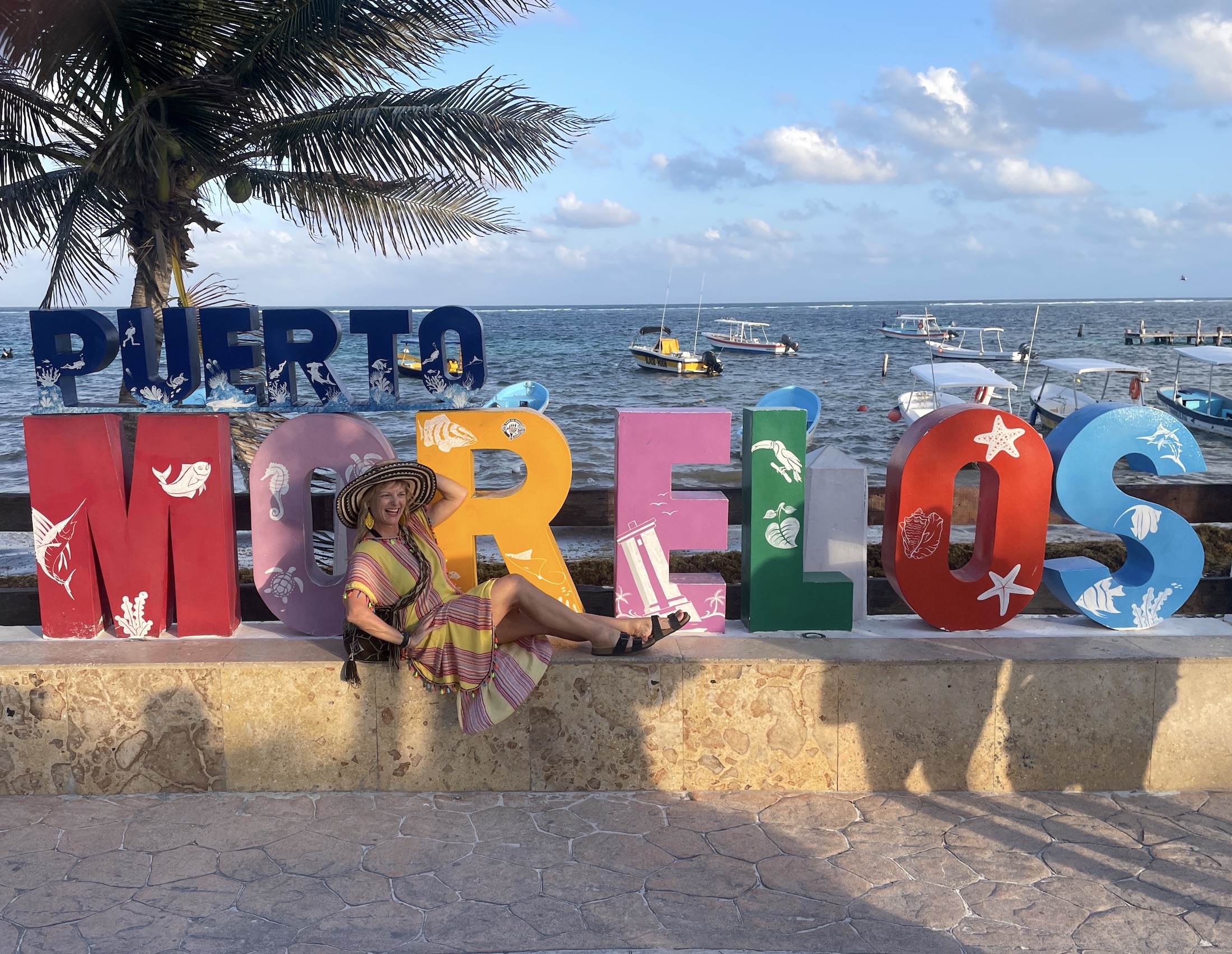 Kate Dana in front of Las Letras in the marina of Puerto Morelos, Quintana Roo, Mexico photo ©2023 Kate Dana