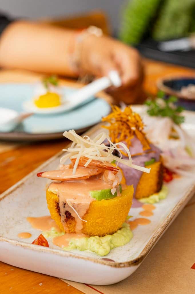 A plate with a trio of prepared Causa, stacked Peruvian salad of tuna and yellow potato, photo © Ruben Dao Cuentas for pexels.com
