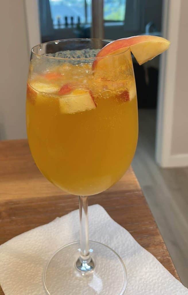A delicious tall, stemmed glass of orange and apple kombucha sits waiting to quench your thirst in the Santa Maria Valley: Best 3-Day Weekend Getaway Guide, Photo © Kate Dana.