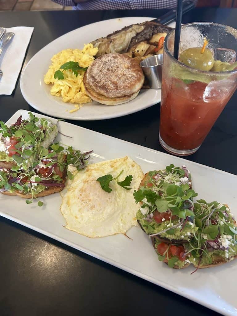 Delicious plates of breakfast fare on a wooden table, photo ©Kate Dana