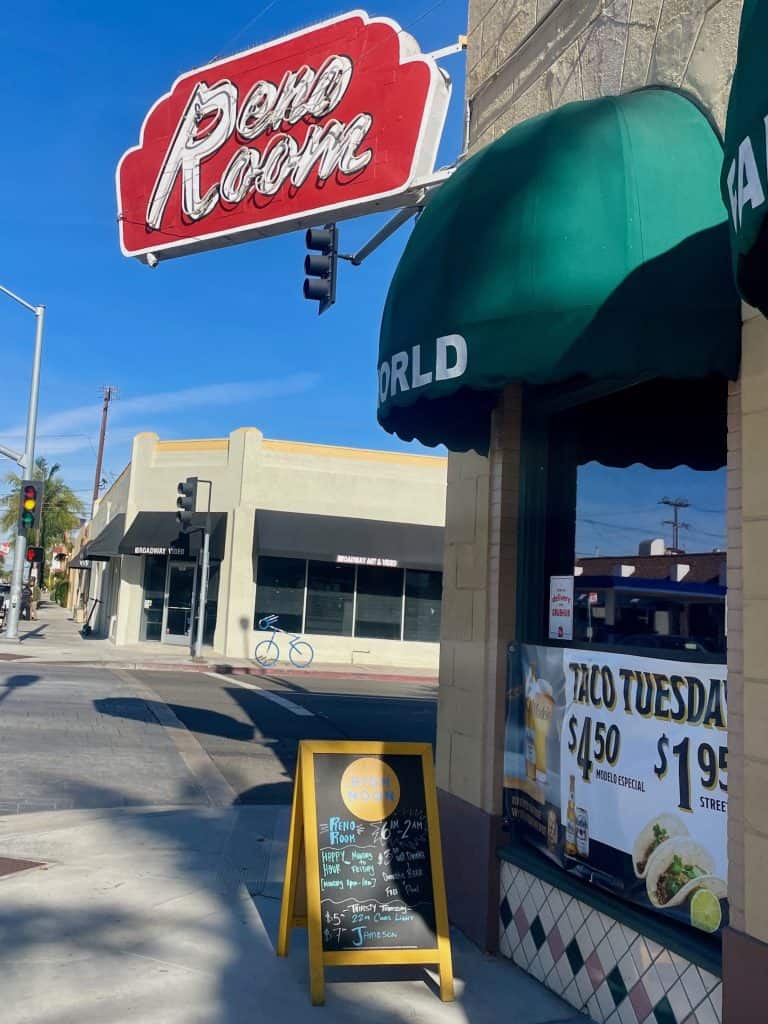 A sign large, red neon sign for the Reno Room hangs off a building over a dark green awning for Cocorenos in Long Beach, CA, home of Long Beach Classic Scooter Club's annual Classic Not Plastic Scooter Rally on Memorial Day weekend, photo ©Kate Dana