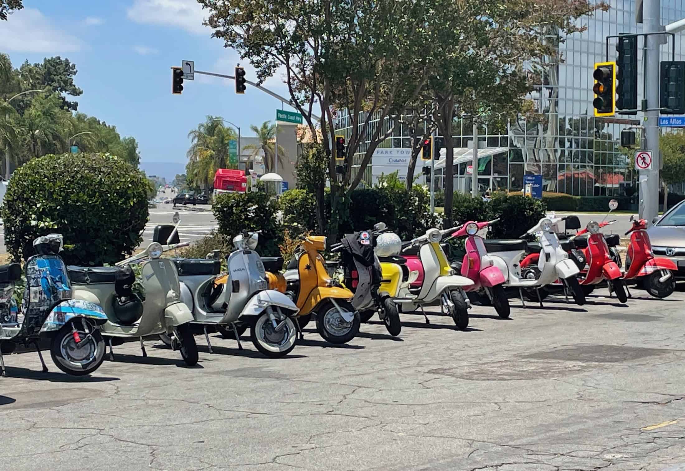 A dozen vintage Lambretta and Vespa motor scooters line the streets near Park Estates in Long Beach, CA, awaiting the start of Long Beach Classic Scooter Club's annual Classic Not Plastic Scooter Rally on Memorial Day weekend, photo ©Kate Dana