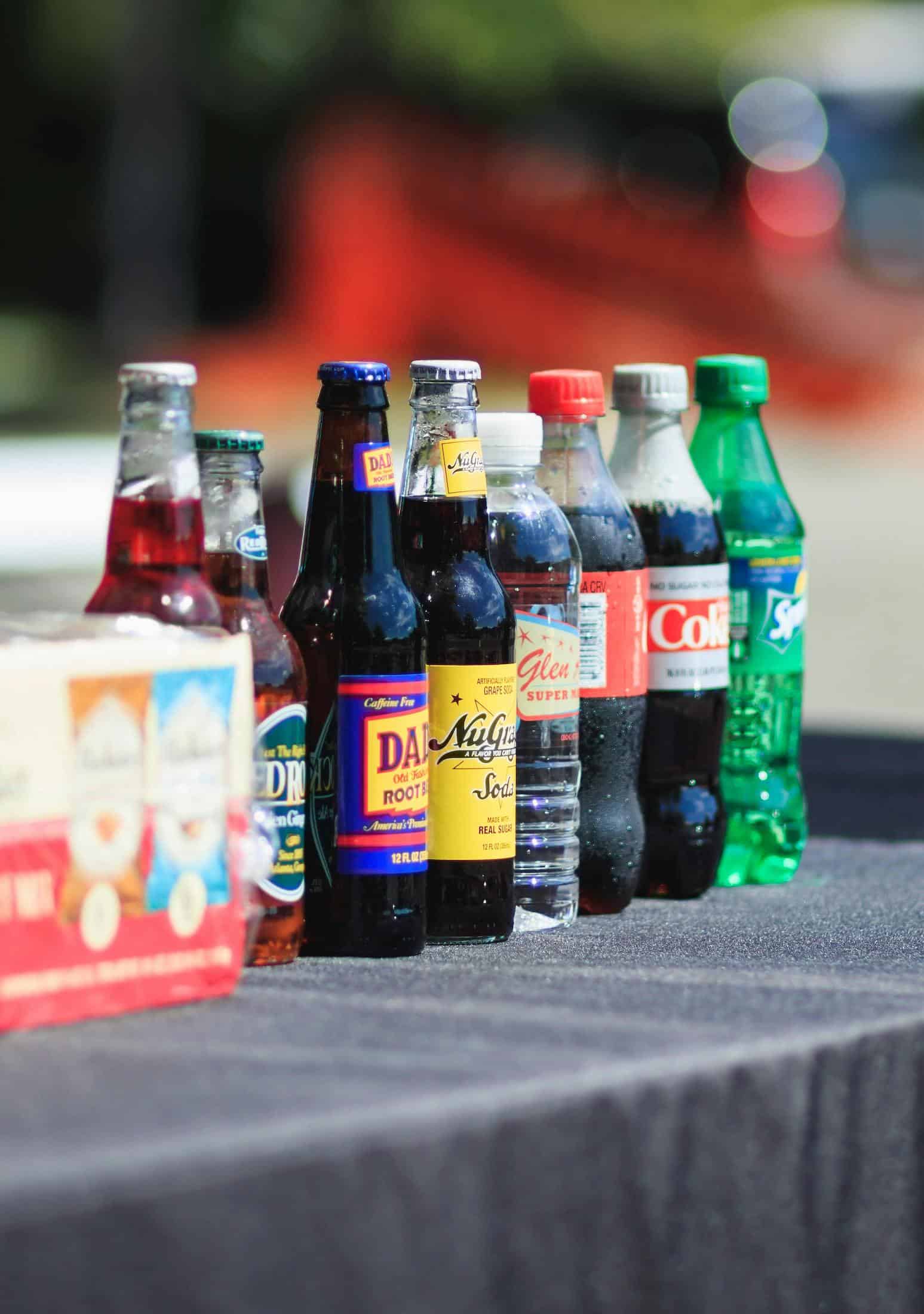Coke: meaning a soda of any kind. Several bottled sodas with colorful labels are lined up together in this color, close-up photo for 78 Southern Phrases to Blow Your Hair Back, Cocameca.com photo ©Michael Morse for Pexels