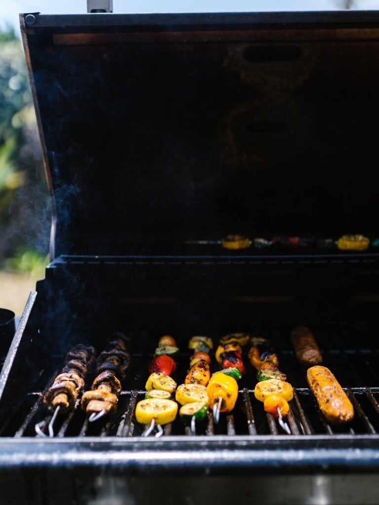 "Cookout": Several meats and vegetables on kabobs on a hot charcoal grill lined up together in this color, close-up photo for 78 Southern Phrases to Blow Your Hair Back, Cocameca.com photo ©Canva