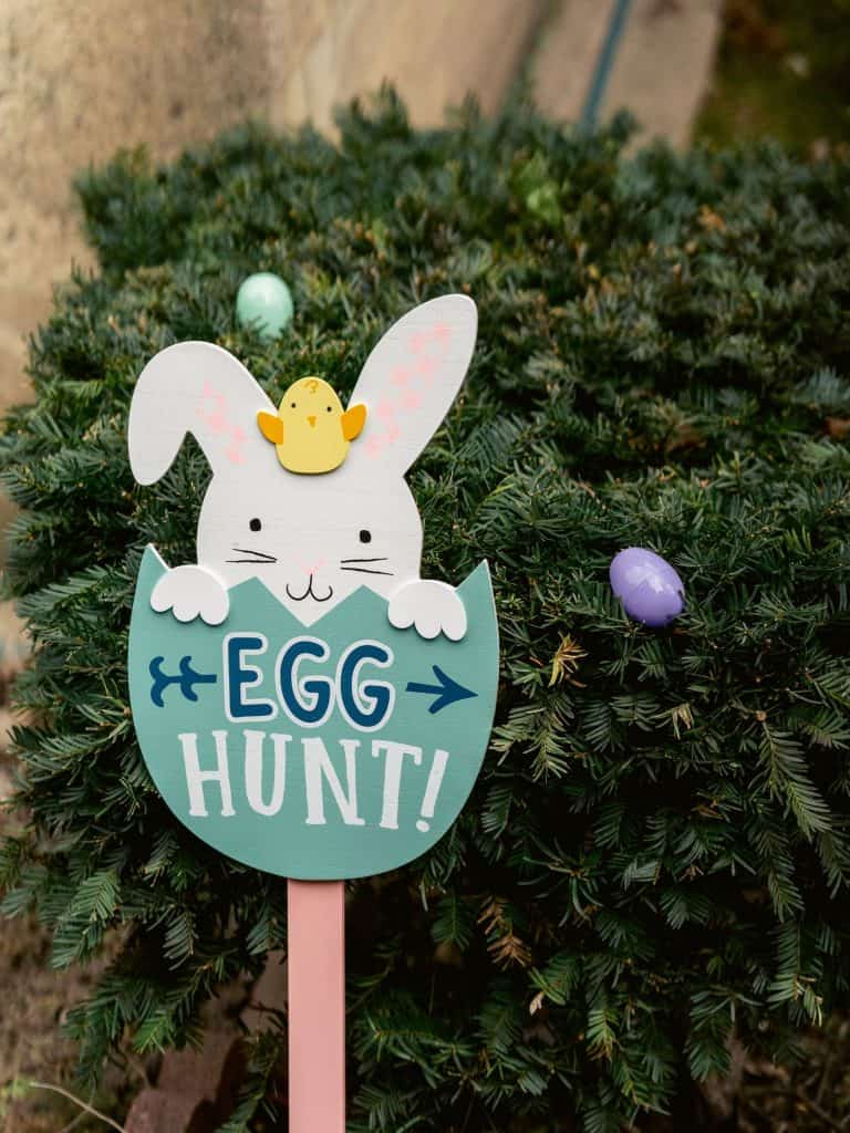 "She's as lost as last year's Easter eggs": A sign announcing an Egg Hunt with a bunny popping up from a blue egg in this color, close-up photo for 78 Southern Phrases to Blow Your Hair Back, Cocameca.com photo © Canva