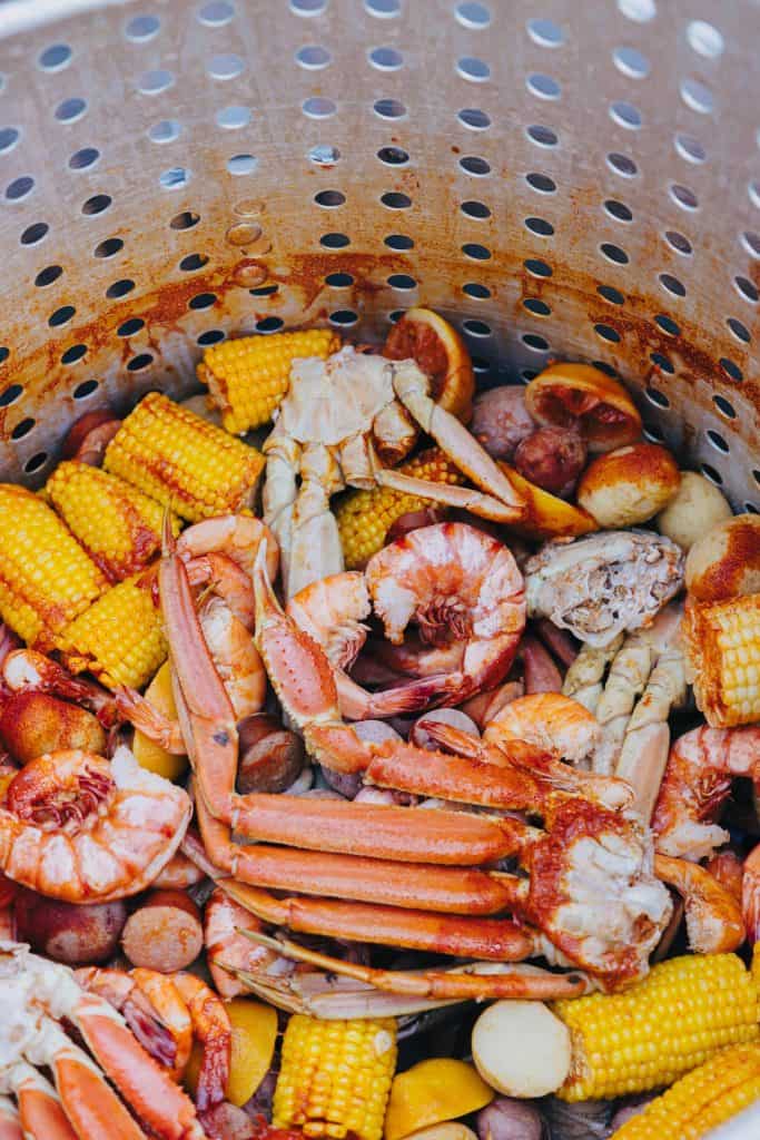 "Lowcountry Boil": A large pot of crawfish, shrimp, sausage, potatoes, corn on the cob and crab are featured in this color, close-up photo for 78 Southern Phrases to Blow Your Hair Back, Cocameca.com photo © Kelly for PexelsSunira Moses for Unsplash