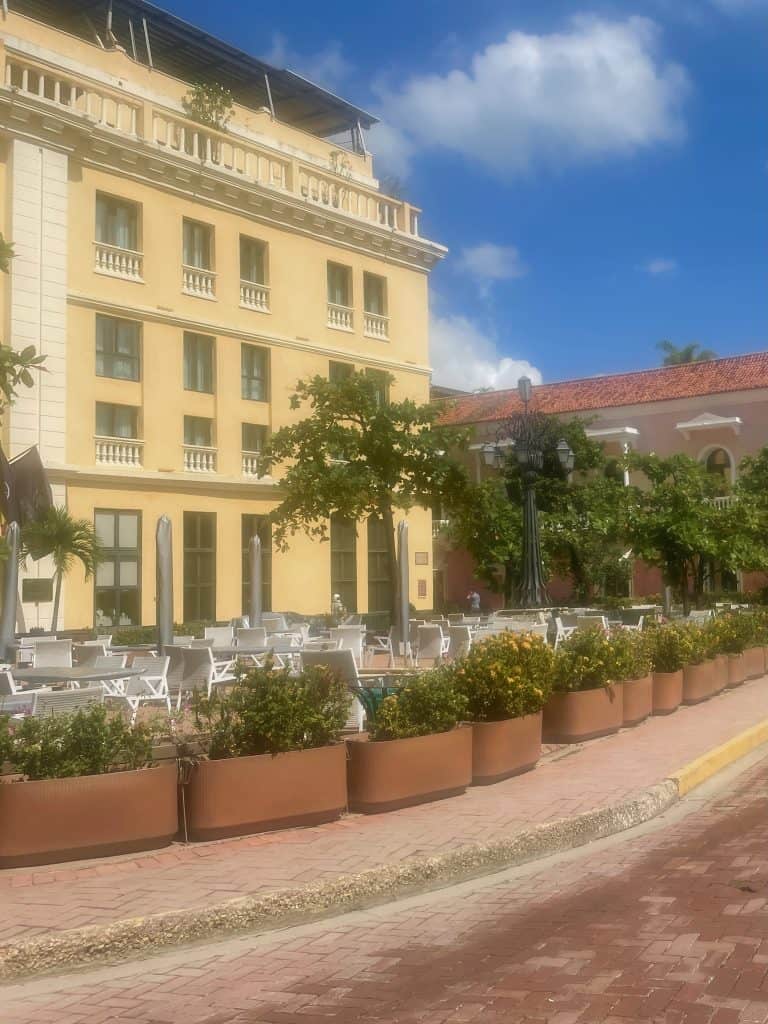 The pale yellow facade of the impressive Hotel Charleston de Plaza de Santa Teresa gives a soft glow in the afternoon in Cartagena, Colombia, a city similar to Charleston, S.C., photo ©Kate Dana