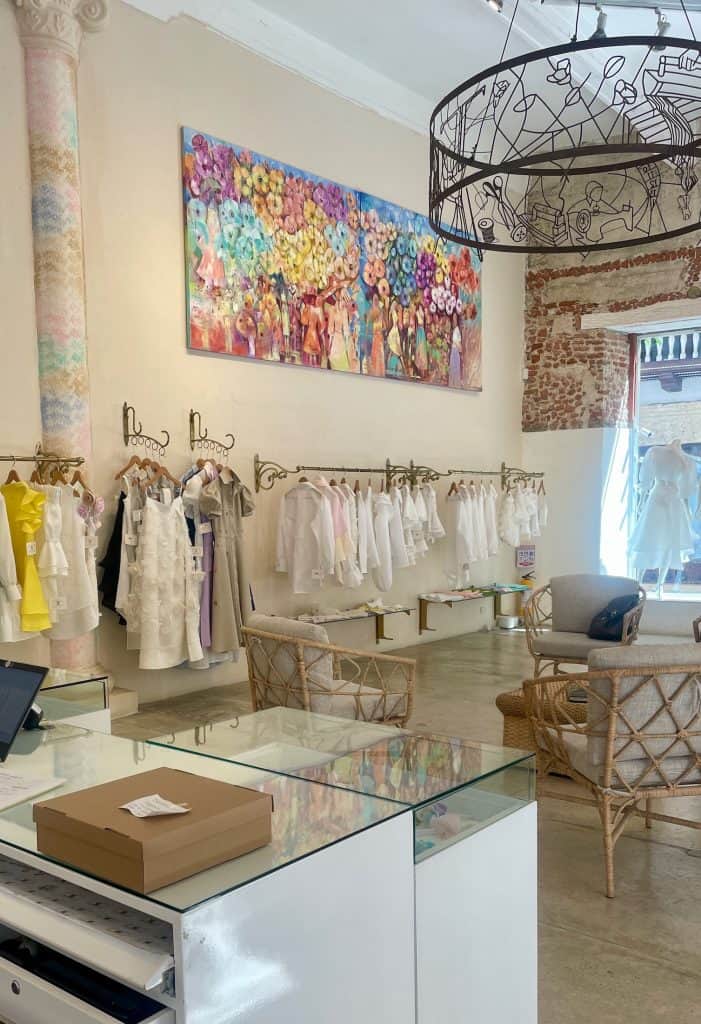 Fine linen clothing hangs on display racks inside the elegant shopping establishment for Ketty Tinoco, La Dama de Lino, located in the Centro in Cartagena, Colombia, a city similar to Charleston, S.C., photo ©Kate Dana