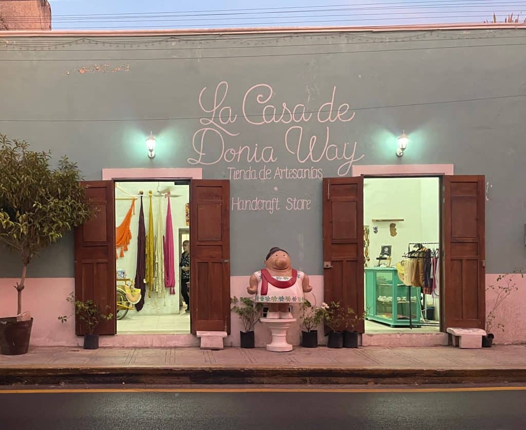 The outside windows and painted facade of La Casa de Donia Way Tienda de Artesanos in Merida, Mexico, photo ©Kate Dana