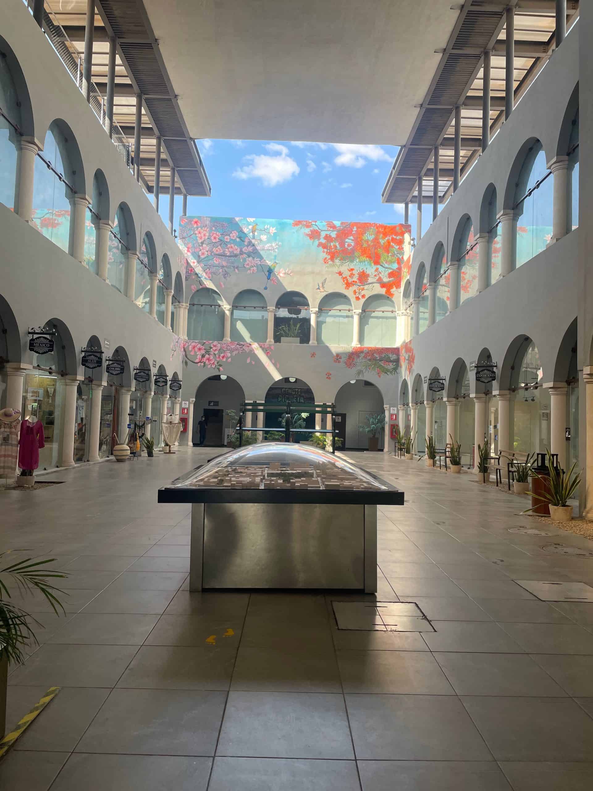 Glass arches tower overhead, enclosing the passage and main corridorof Pasaje Revolución in Mérida, México, photo ©Kate Dana