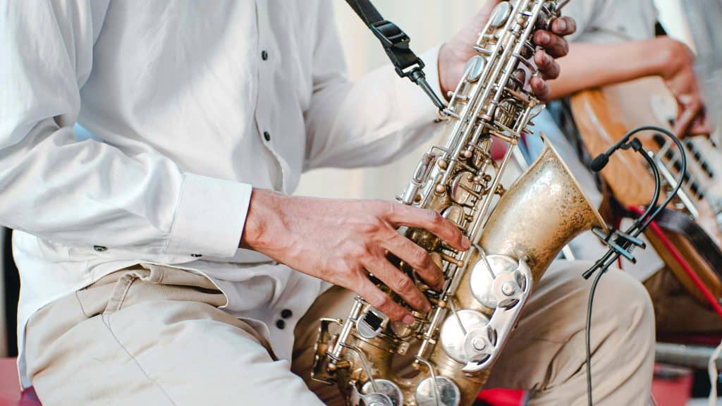 A close up image of a person playing a brass saxophone, photo ©Photo Yeremia Krisnamurti for Pexels