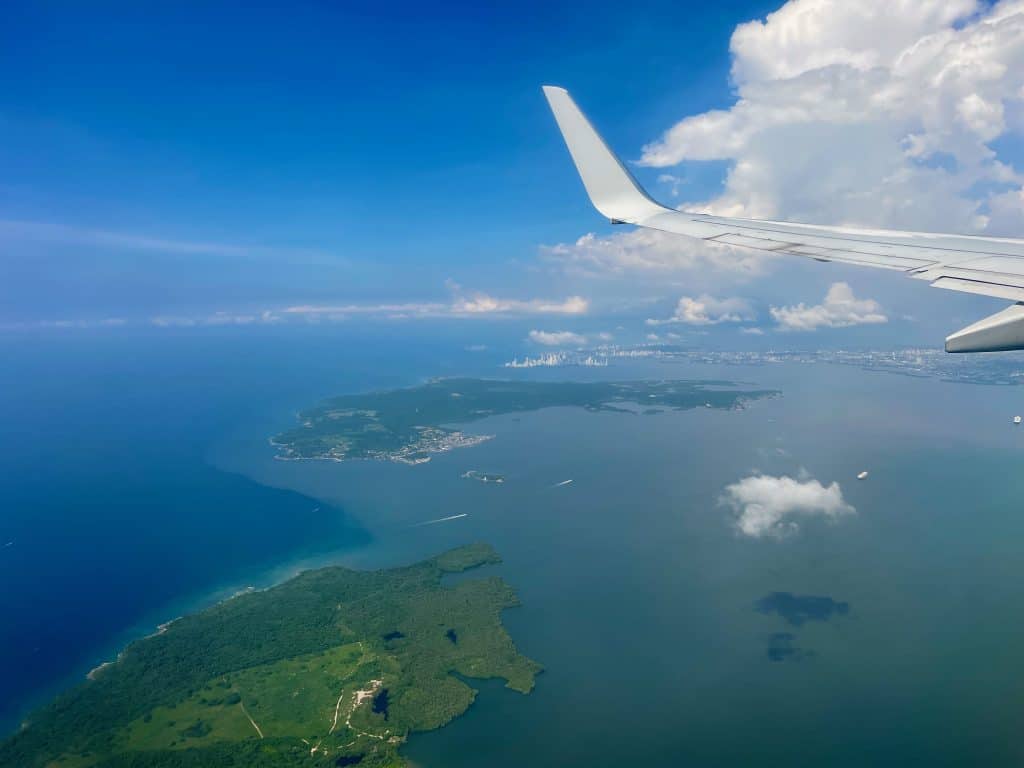 The blue water and green lush land of Colombia as seen from an airplane window approaching Cartagena, photo © Kate Dana