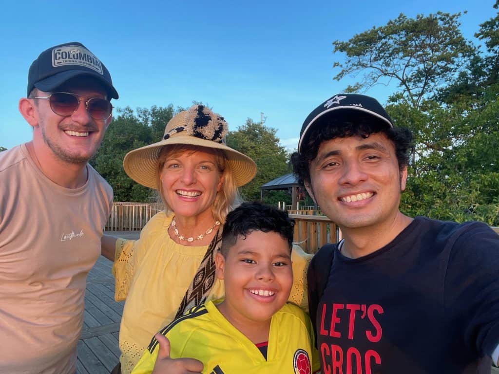 Cocameca founder Kate Dana smiles next several friends outdoors in Colombia, photo ©Kate Dana
