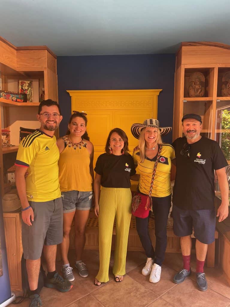 Several people group together and smile indoors at Casa de Colombia in Balboa Park, San Diego, photo ©Kate Dana