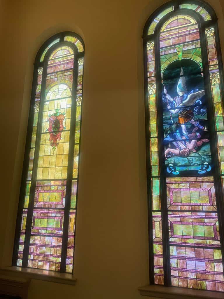Two large colorful stained glass windows in the staircase of Calvary Presbyterian Church in San Francisco, leading to the balcony, photo ©Kate Dana