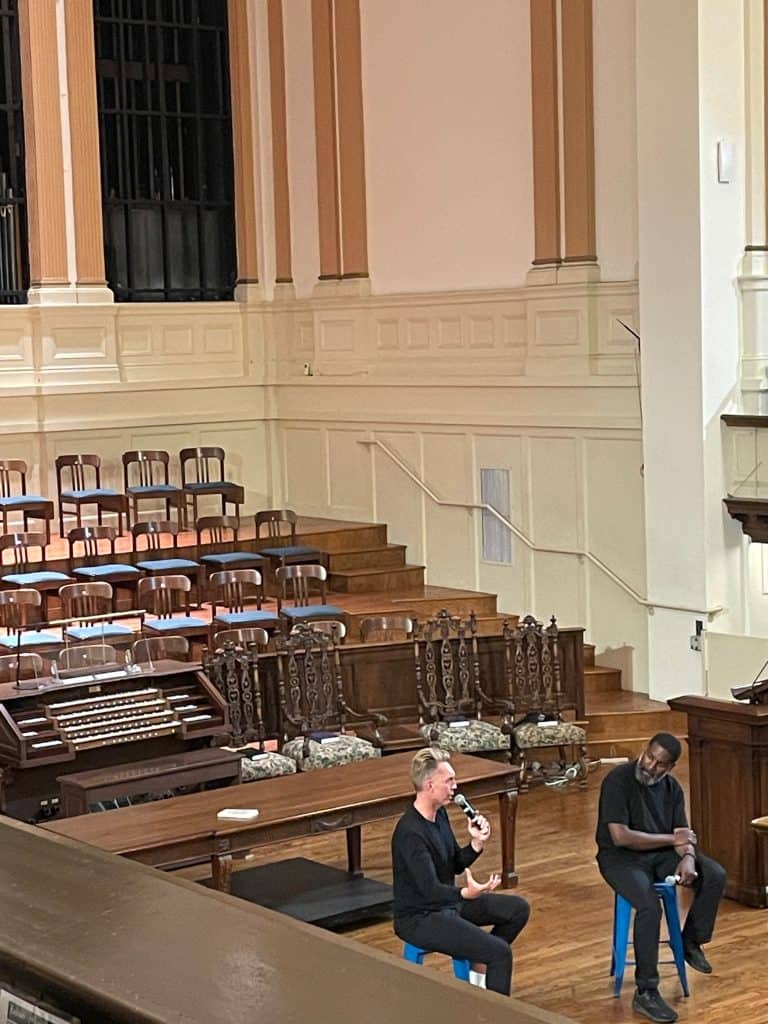 Joshua Fields Millburn and T.K. Coleman, two members of The Minimalists, sit on stools and talk at Calvary Presbyterian Church in San Francisco, CA, photo ©Kate Dana