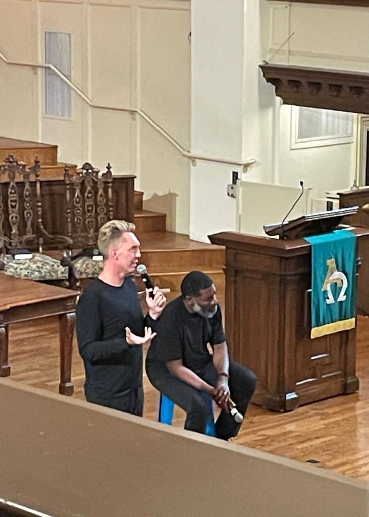 Joshua Fields Millburn and T.K. Coleman, two members of The Minimalists, sit on stools and talk at Calvary Presbyterian Church in San Francisco, CA, photo ©Kate Dana