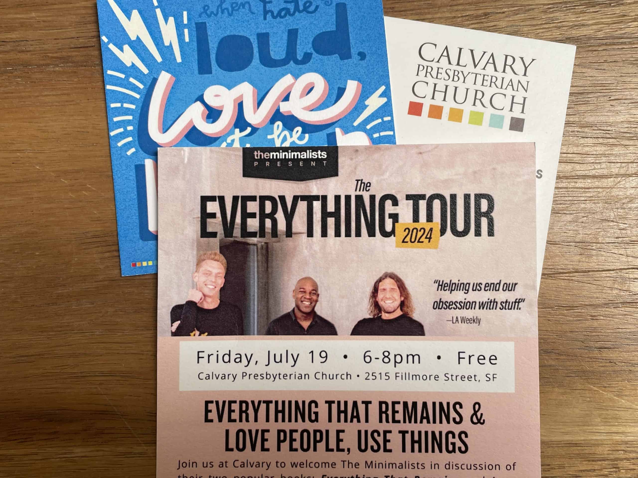 A colorful postcard announcing a tour stop date for The Minimalists in San Francisco, CA at Calvary Presbyterian Church on a wood background, photo ©Kate Dana