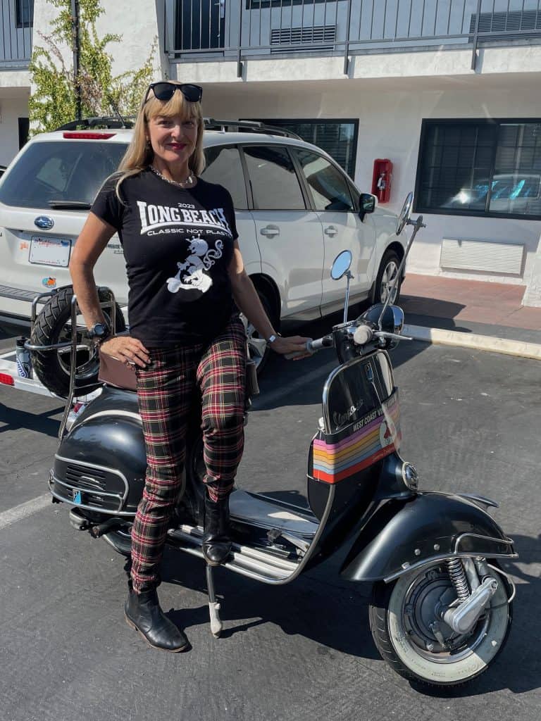 Cocameca founder Kate Dana stands next to a silver vintage Vespa Sprint 150 at West Coast Vintage Vespa Days 2023, photo ©Kate Dana