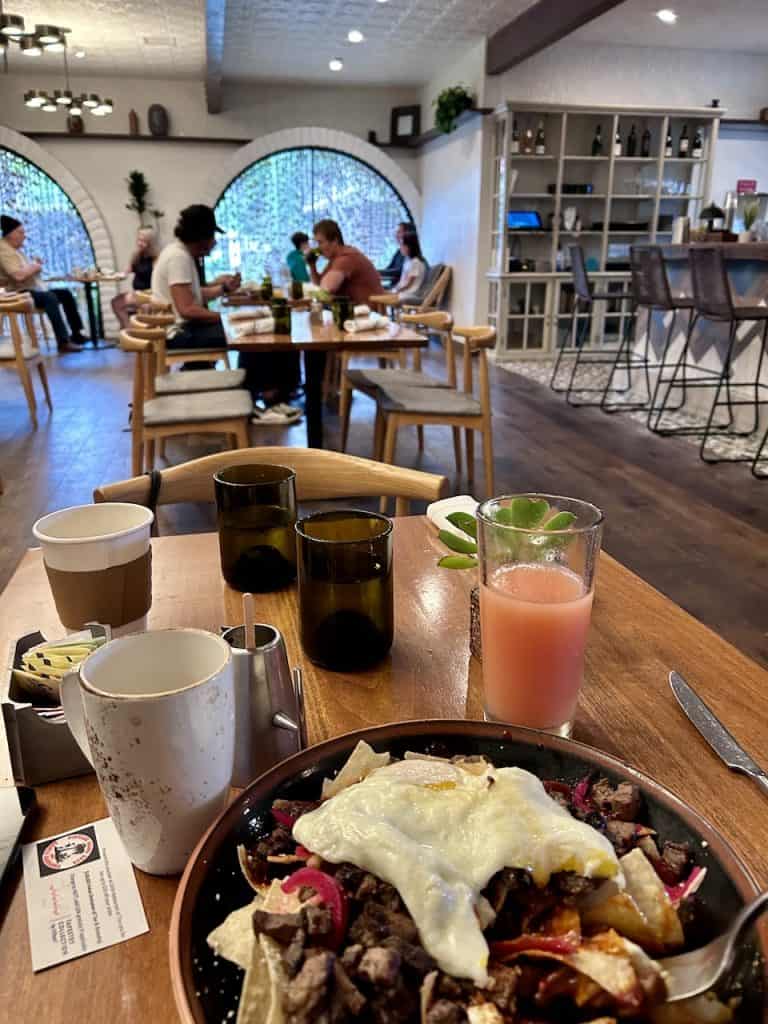 A plate of warm chilaquiles on a table in the dining room at The Leta hotel in Goleta, CA, photo ©Kate Dana