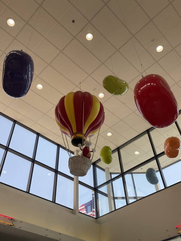 Large fiberglass candies and jelly beans the size of sofas hang overhead in the lobby of the Jelly Belly Factory in Fairfield, CA, photo ©Kate Dana