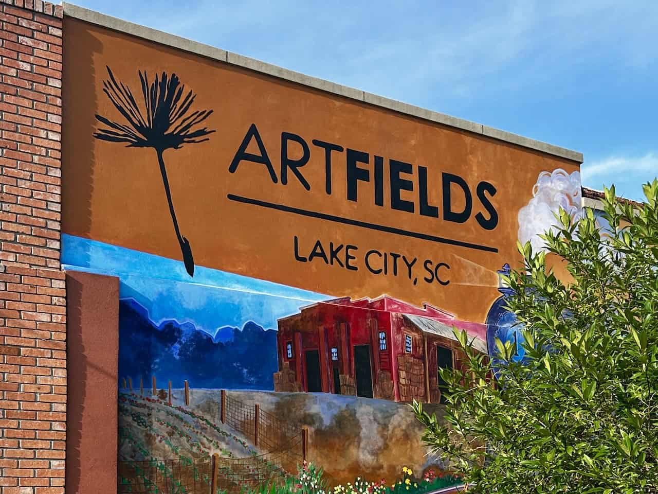 A large colorful mural on a building wall announces Artfields in Lake City, South Carolina, photo ©Kate Dana