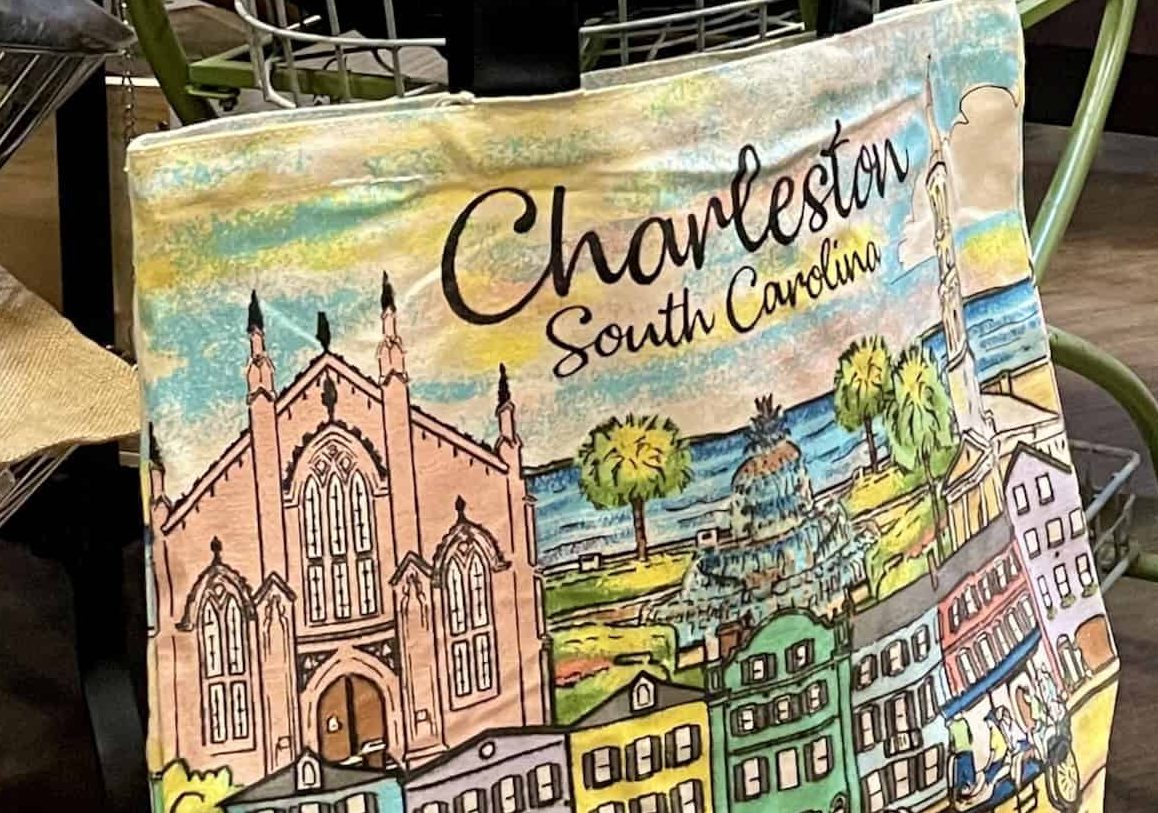 A colorful tote bag with an illustration of the iconic houses of Rainbow Row in Charleston, S.C., photo ©Kate Dana