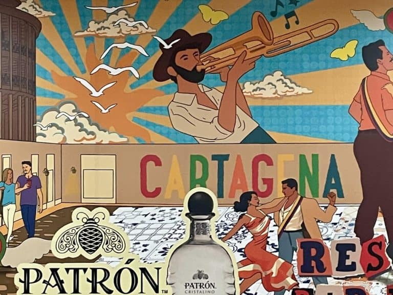 A colorful mural of Cartagena featuring people and musical artists