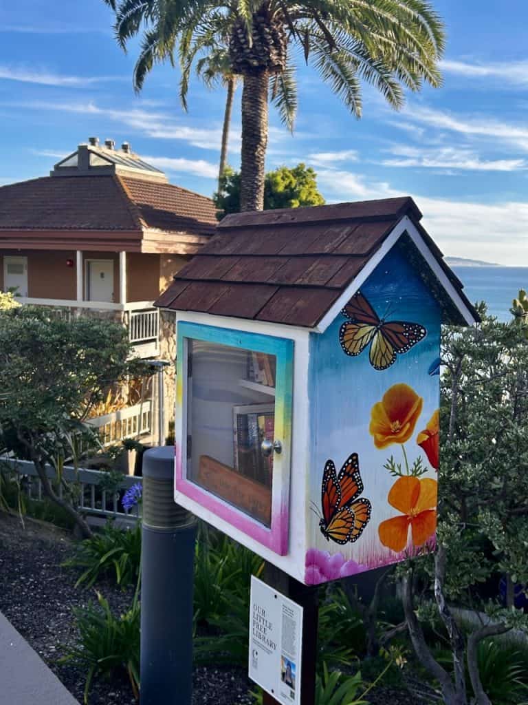 A colorful painted box holds books at a Little Free Library on the grounds of Inn at the Cove, near Pismo Beach, California