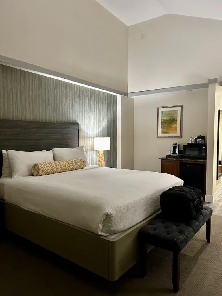 A large bed with fine linens in a room at Inn at the Cove, near Pismo Beach, California