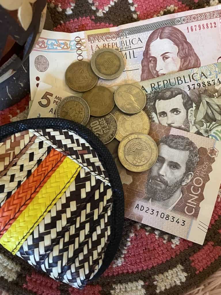 Colombian pesos in colorful bills and shiny coins photo ©Kate Dana