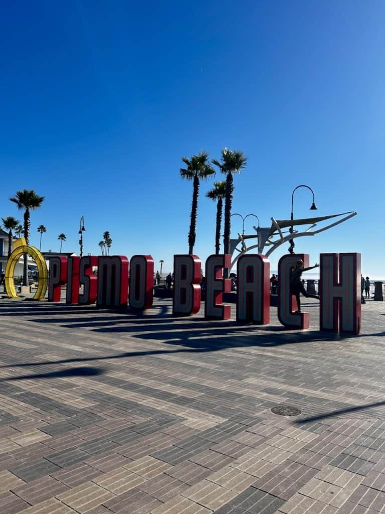 Huge letters spell out Pismo Beach at the Pier Plaza near the ocean in the town of the same name, California