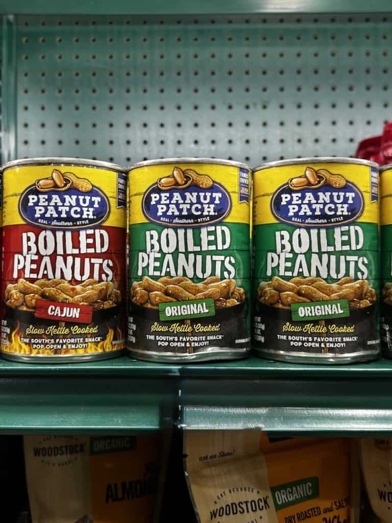 Colorful cans of original and Cajun flavor Peanut Patch boiled peanuts on a store shelf, photo ©Kate Dana