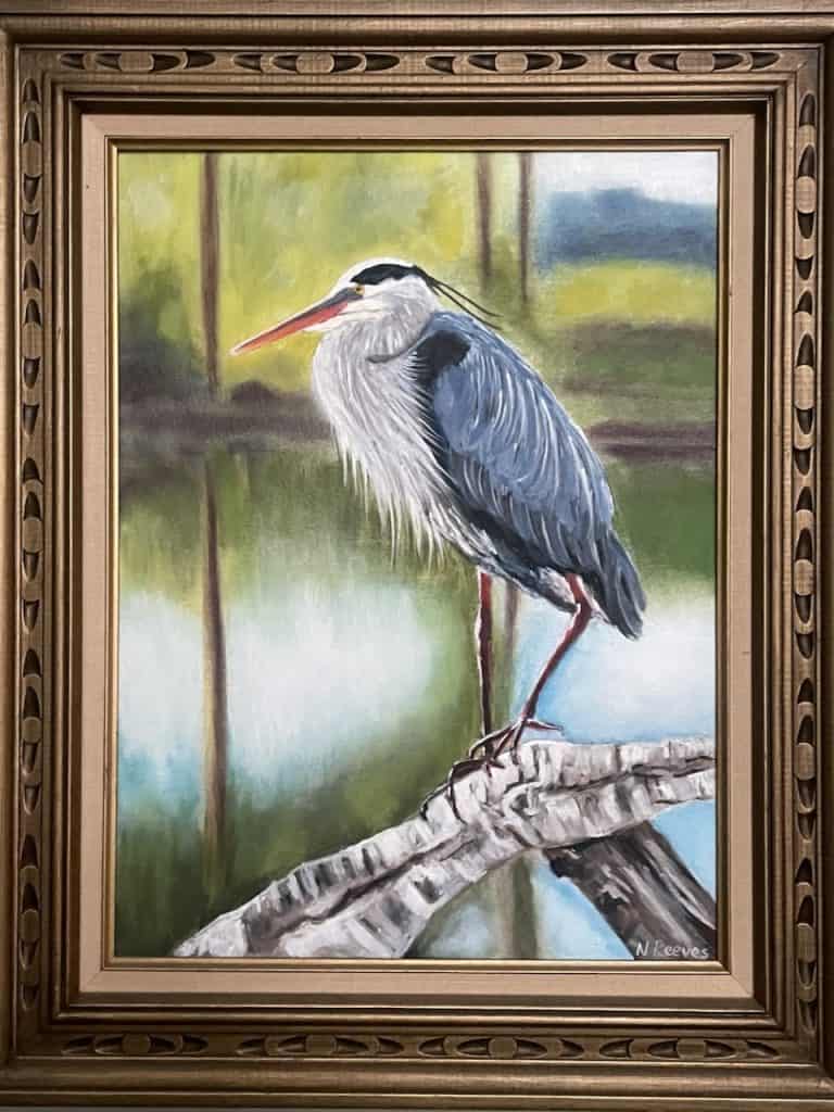 A painting of a blue heron in a gold frame by Charleston Artist Guild & CAG Gallery member Natalia Reeves, photo ©Kate Dana
