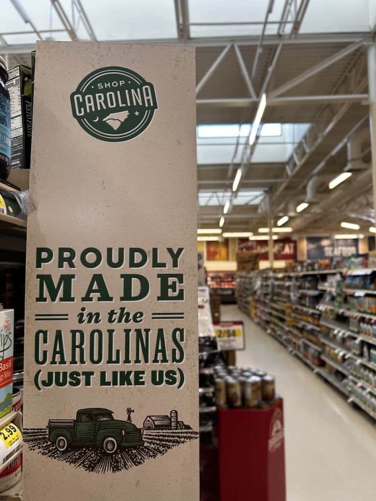 A sign hung near store shelves stocked with merchandise boasts, "Proudly made in the Carolinas" photo ©Kate Dana
