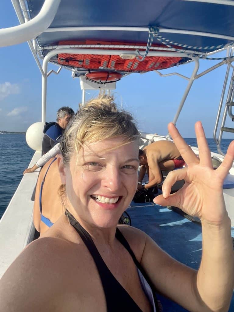 Kate Dana, founder of Cocameca, gives the OK diver sign before a dive in Cozumel, Mexico, photo ©Kate Dana
