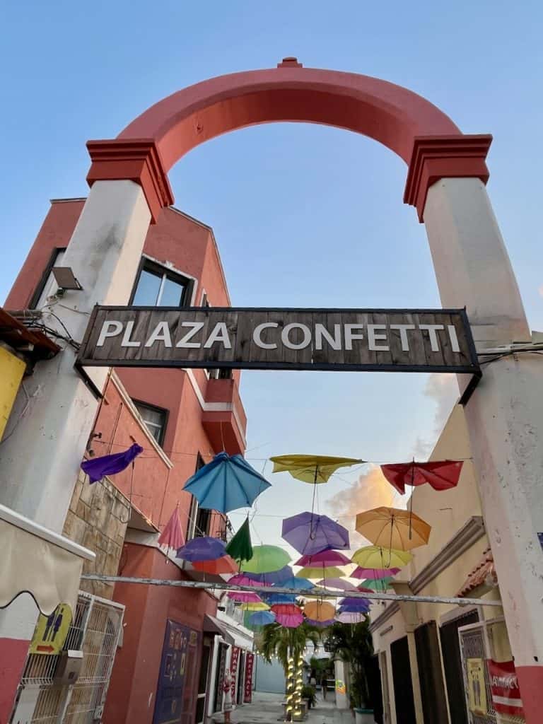 Colorful umbrellas line the rooftops over Plaza Confetti in Isla Cozumel, Mexico, photo ©Kate Dana