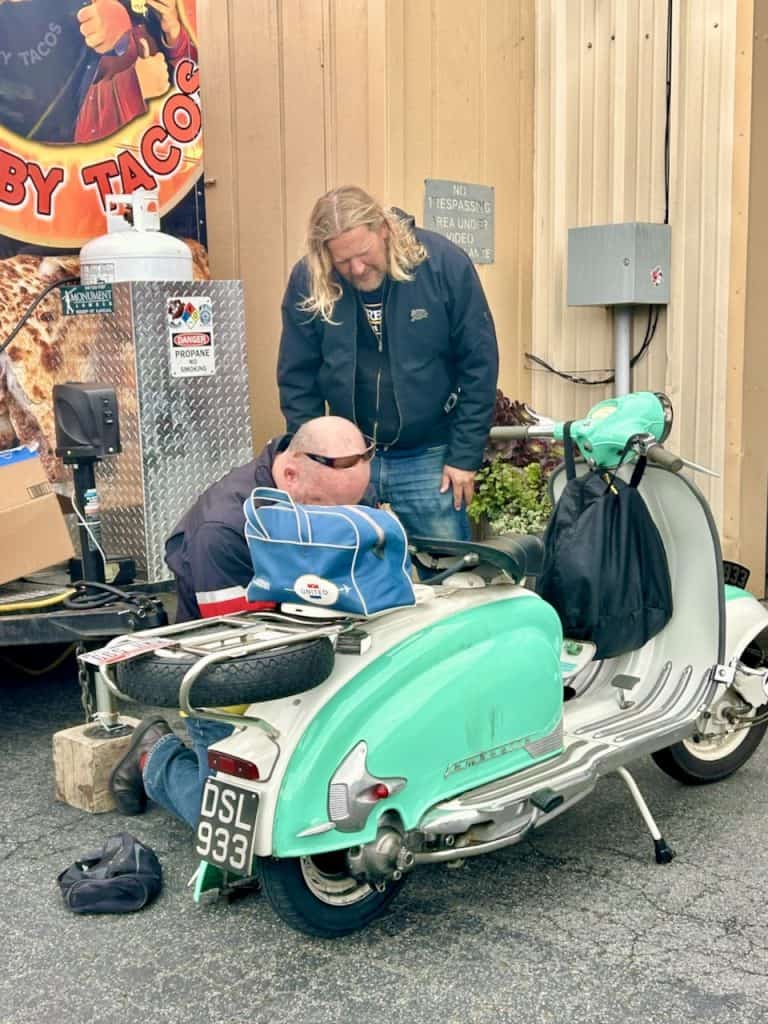 Scooterists work on a vintage Lambretta near the Santa Cruz Cider Company in Watsonville, CA, photo ©Kate Dana