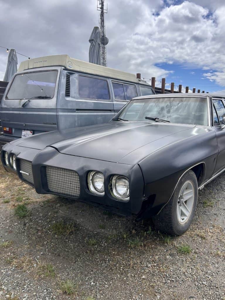 A black, vintage Pontiac LeMans with a custom grill near The Hangar in Watsonville, CA photo ©Kate Dana